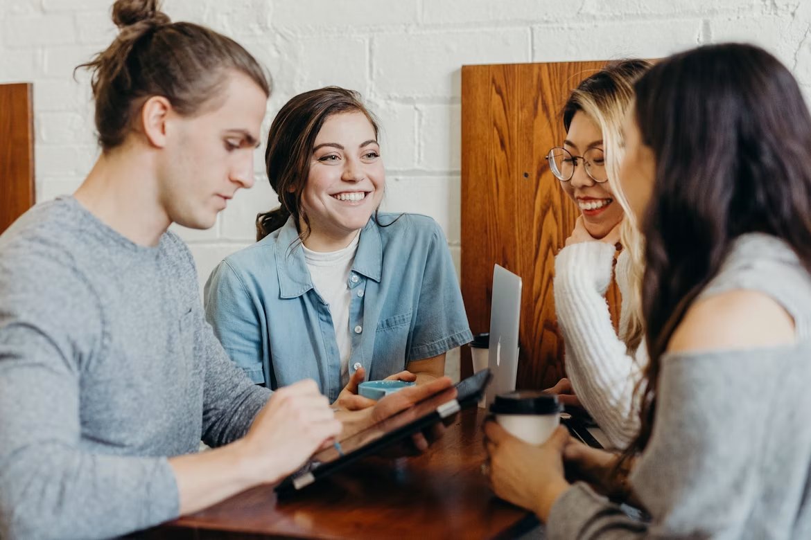 Colleagues smiling together around a table