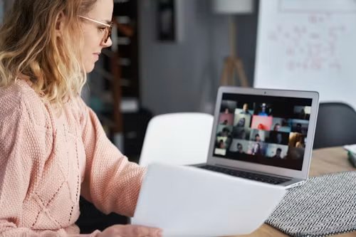 A woman joining a live online training session on her laptop